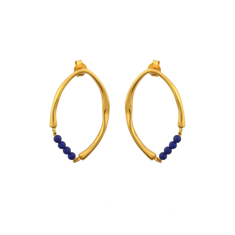 A pair of Shyla Thiva Earrings featuring an asymmetrical, twisted design in 22 carat gold. Each elegant earring has a row of small, round blue beads at the bottom. The earrings have a shiny finish and are displayed on a white background.