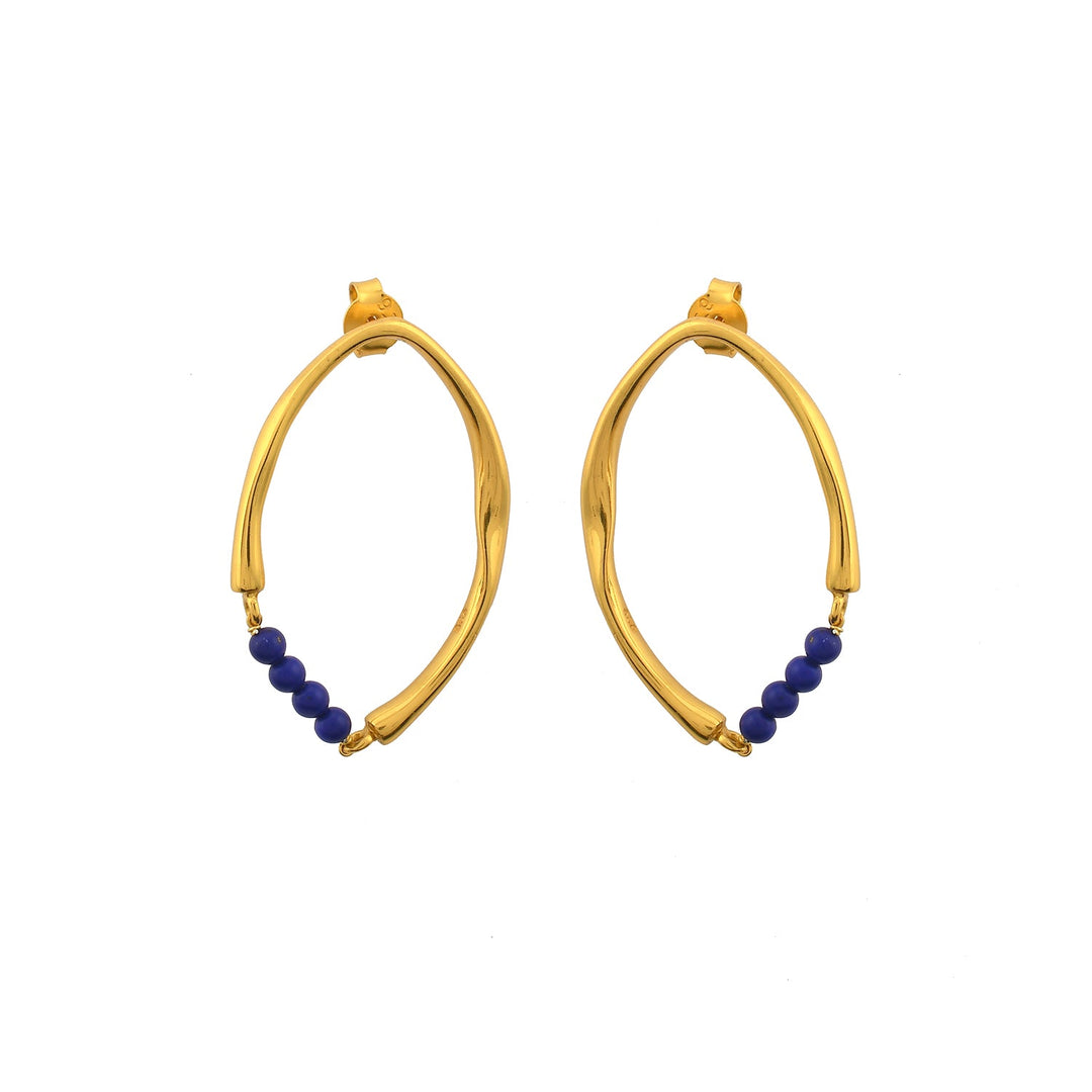 A pair of Shyla Thiva Earrings featuring an asymmetrical, twisted design in 22 carat gold. Each elegant earring has a row of small, round blue beads at the bottom. The earrings have a shiny finish and are displayed on a white background.