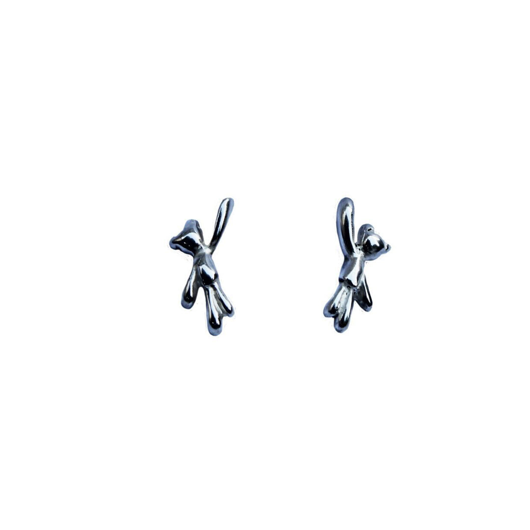 Kate Murphy Teddy Bear Silver Stud Earrings are handmade sterling silver studs shaped like stylized teddy bears, each with a raised arm, shown on a plain white background.