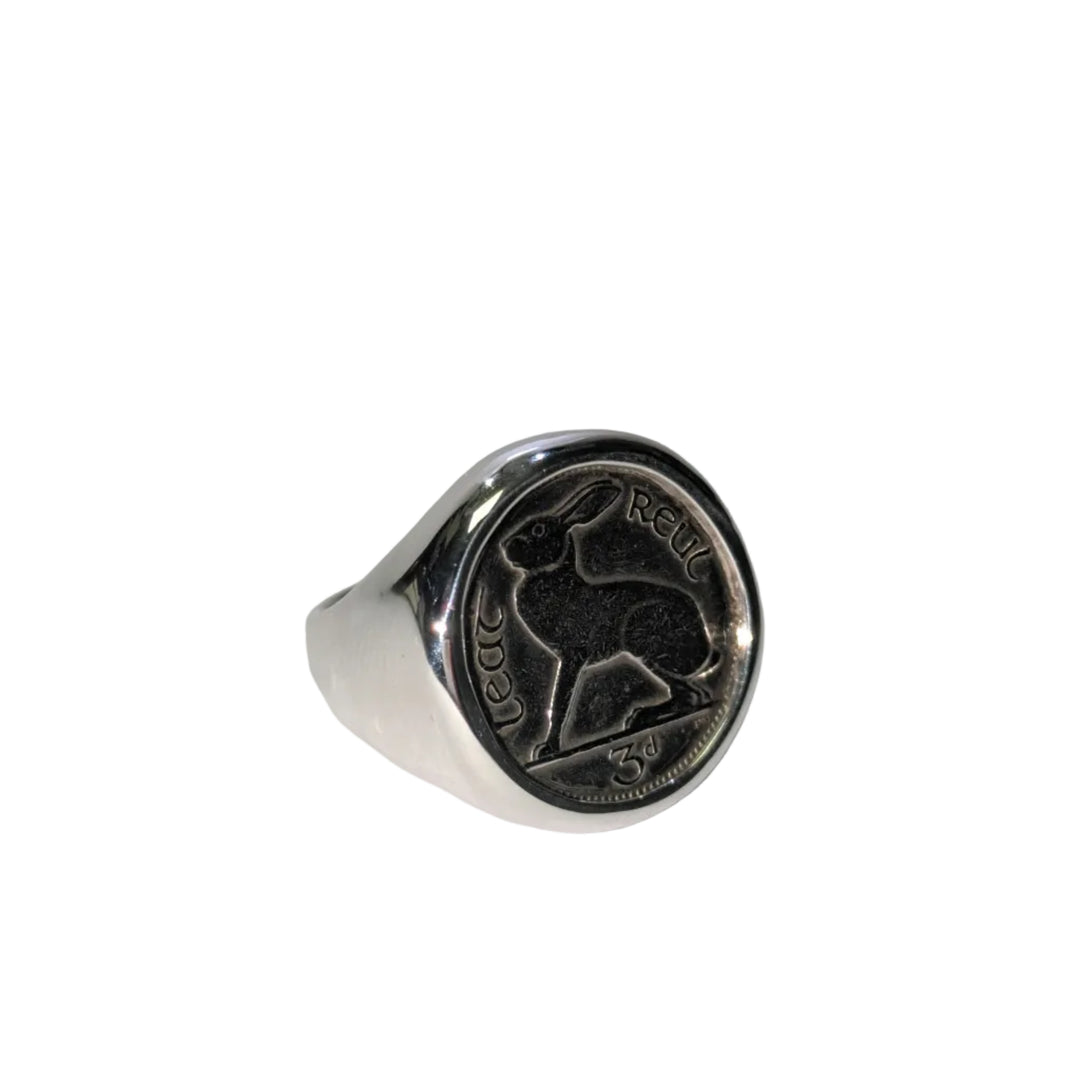 A sterling silver round signet ring with old Irish threepence coin.