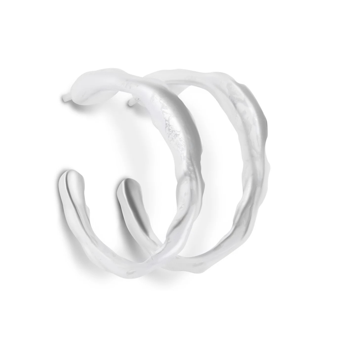 The Waves of The Irish Sea Silver Hoop Earrings by Ava Jane Jewellery are irregularly shaped hoops with a wavy, organic texture, inspired by the Irish Sea and shown on a white background.