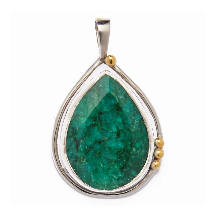 The Poppy Pendant Large in various gemstones by Gallardo & Blaine Designs features a teardrop-shaped design with a large, green labradorite stone at its center, encased in a sterling silver frame. Adorned with small gold accents on one side, it creates an elegant asymmetrical look. A simple silver bail completes this stunning piece.