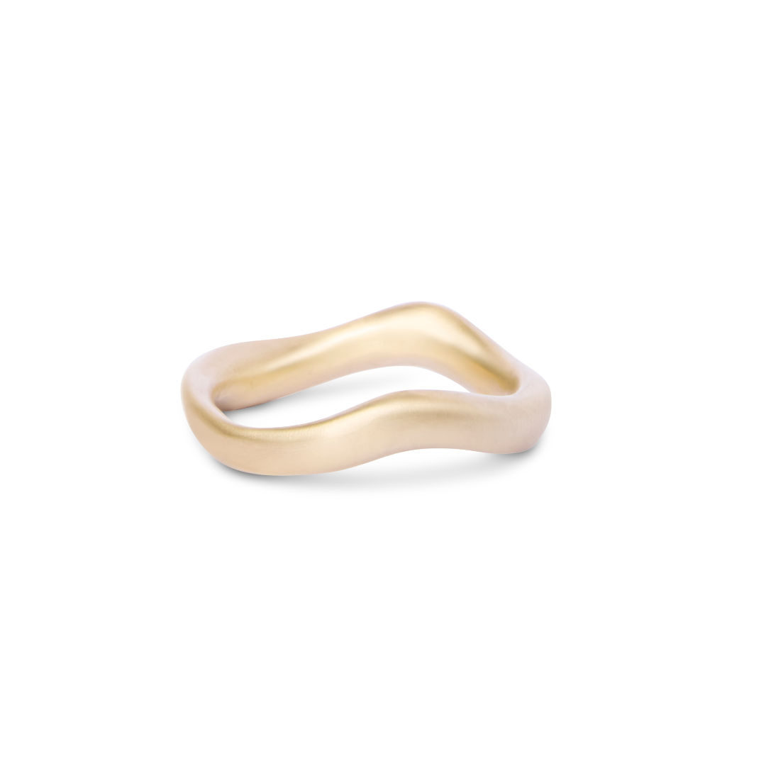 The Thorn Ring by Madeleine Sculptural Jewellery features a smooth, organic wavy design in matte gold, handcrafted from recycled brass and shown against a white background.
