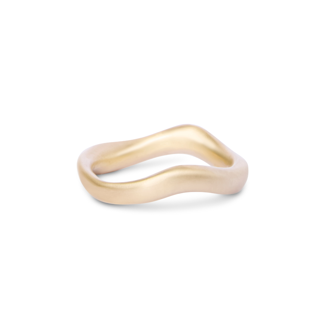 The Thorn Ring by Madeleine Sculptural Jewellery is a handmade, matte gold ring with a smooth, organic wavy shape, shown against a white background.