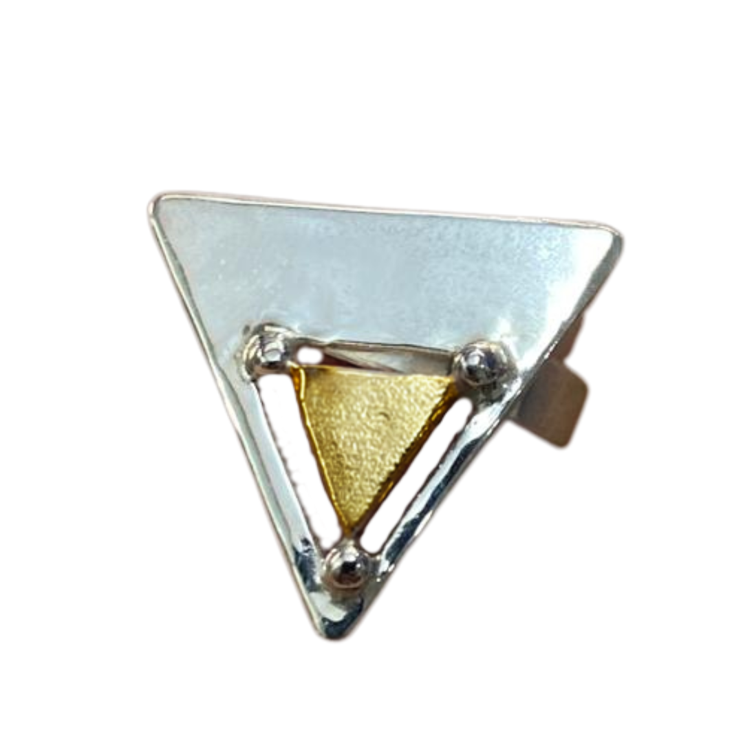 The Triune Ring by Gallardo & Blaine Designs features a shiny sterling silver triangular design with a small gold vermeil inset bordered by silver edges and circular corner accents, showcasing a geometric metal mix design.