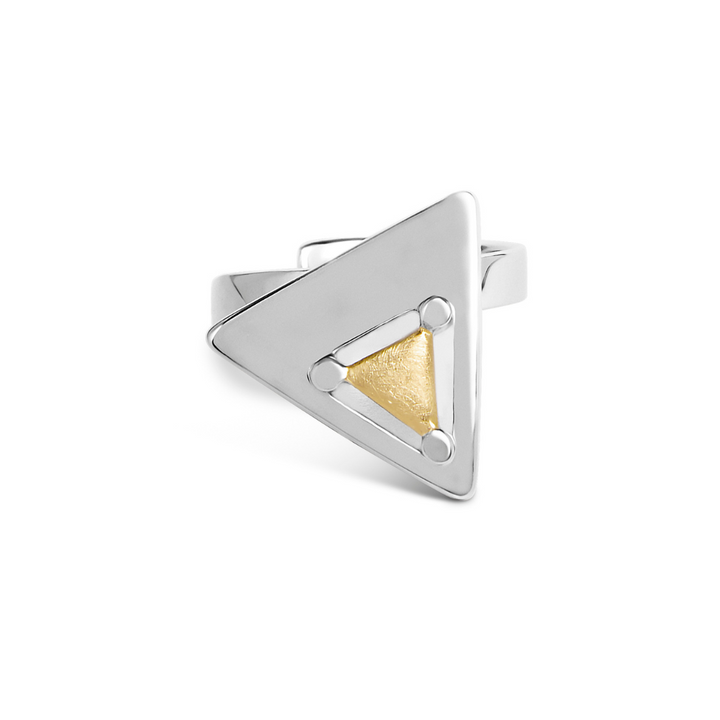 The Triune Ring by Gallardo & Blaine Designs is a sterling silver band with a raised geometric triangle, featuring a smaller gold vermeil triangle at its center and three silver dots at each corner—a polished, modern statement piece.