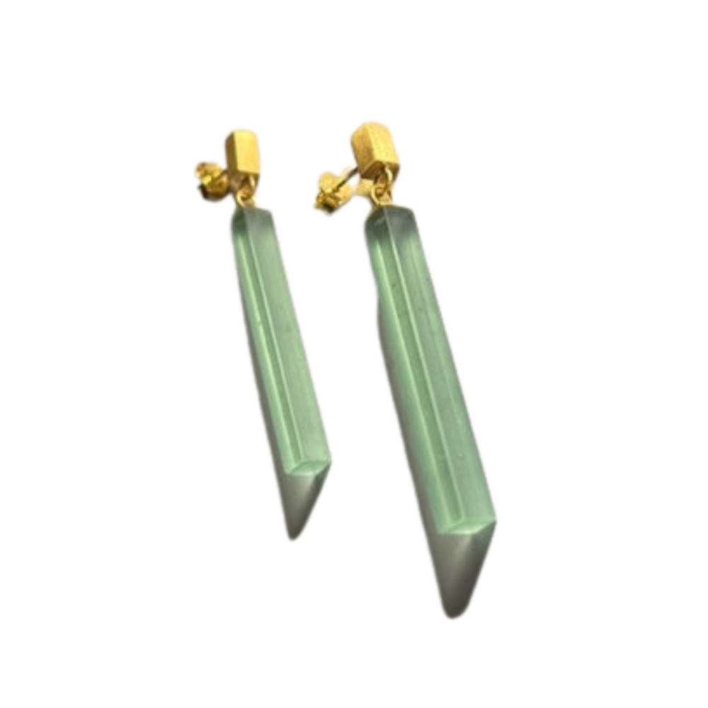 Beira by Irene Reyes’ Soul Bottle Straight Gold Glass Earrings in green feature long, translucent recycled glass pendants and gold-tone geometric studs for an eco-friendly style.