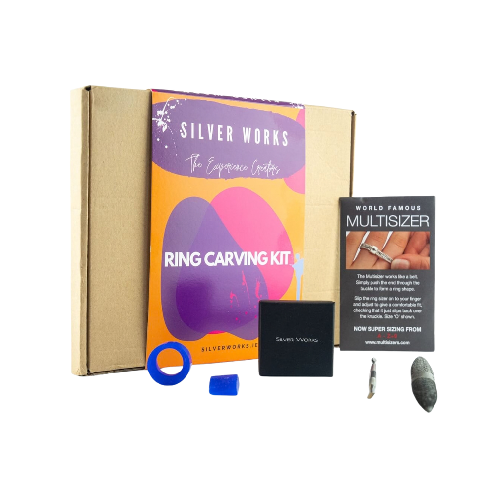 Silver Works - Ring Carving Kit containing a cardboard box with a colorful sleeve, a ring sizer guide, two wax ring blanks, a black jewelry box, and carving tools.