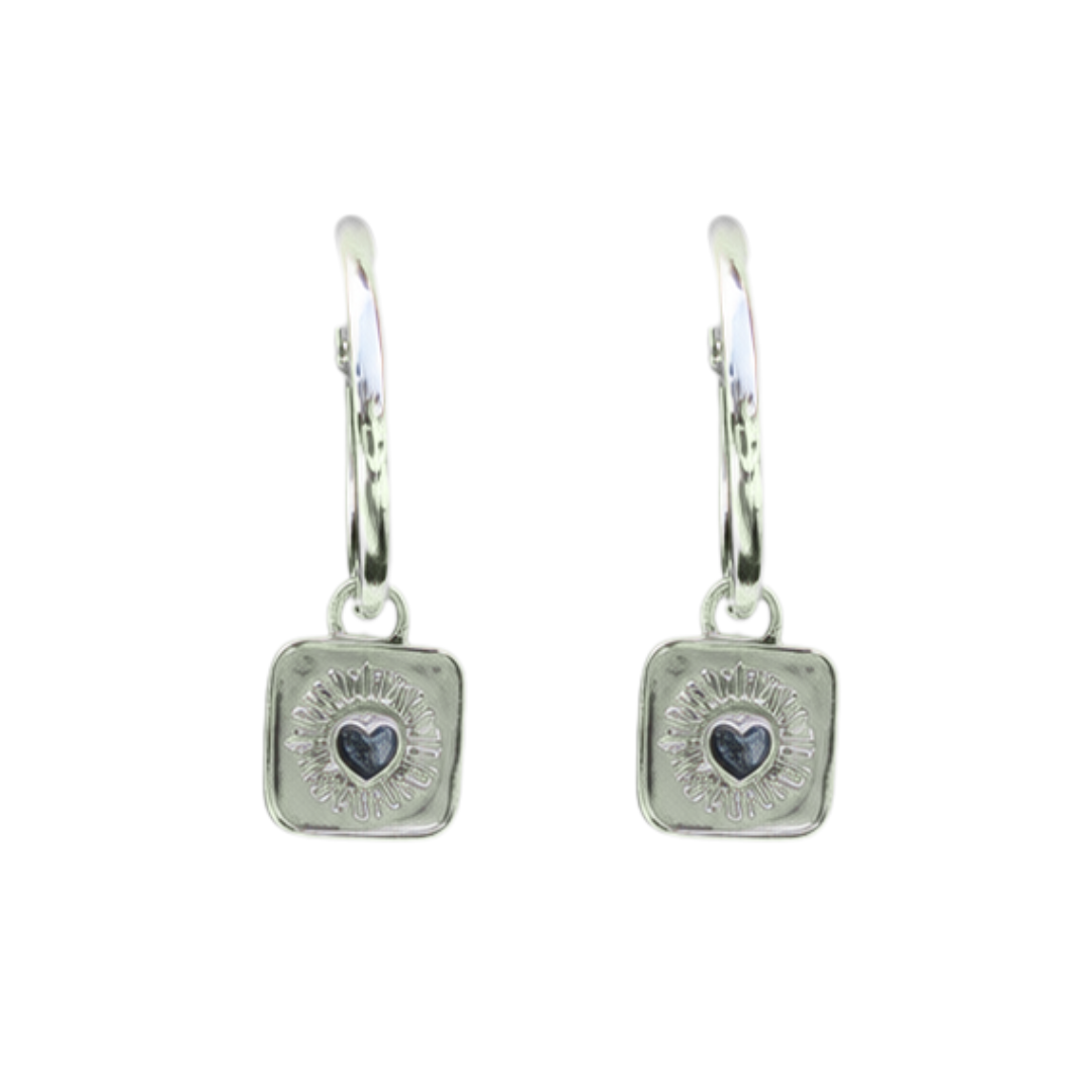 The Collective Dublin’s Keith Haring Inspired Claddagh Hoop Earrings feature charming square charms with heart motifs and sunburst patterns, beautifully handmade as unique Dublin jewelry.