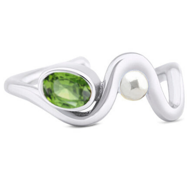 The Adjustable Heartbeat Ring by Gallardo & Blaine Designs features a wavy design with an oval green gemstone and a small round white accent, set in a minimalist style that highlights the elegance of colored gemstones.