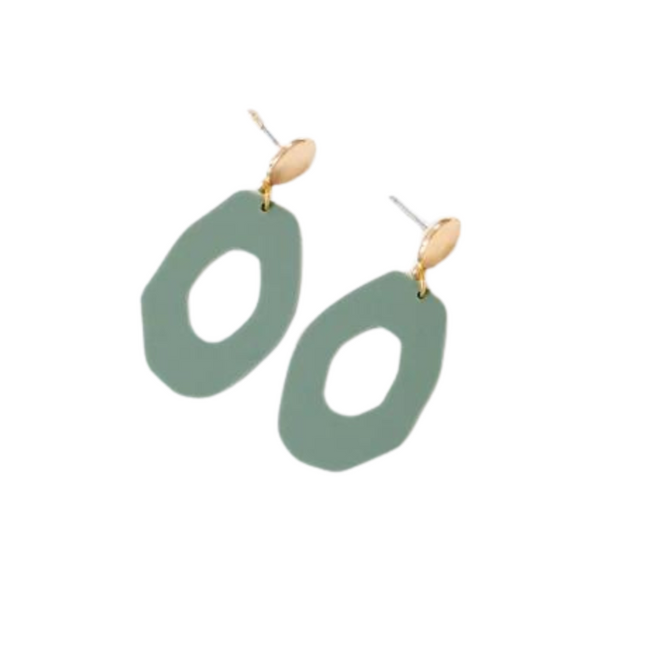 A pair of Studio Nok Nok Sage Green Irregular Oval Acrylic Gold Woods Earrings with abstract, oval-shaped green pendants hanging from small, round, gold-toned studs. Made from recycled acrylic, the lightweight earrings feature irregular open centers, contributing to their unique, modern design.