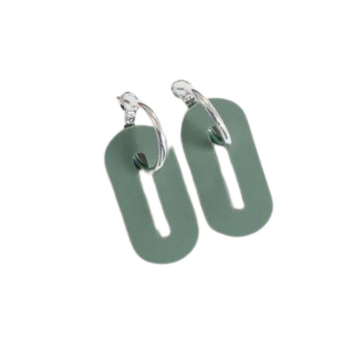 A pair of lightweight earrings featuring silver hoops attached to elongated, oval-shaped green pendants with a vertical cutout in the center. Handcrafted from recycled acrylic, these Studio Nok Nok Sage Green Oval Misty Acrylic Silver Hoop Earrings boast a modern and minimalist design.