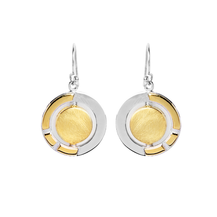 The Urú Dangle Earrings by Gallardo & Blaine Designs feature a round, gold-toned center, silver outer ring with gold accents, and sterling silver hooks—an elegant nod to timeless Irish heritage jewelry.