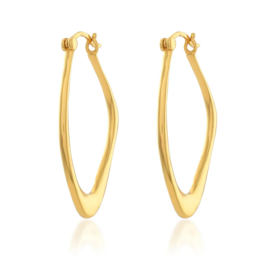 The Valentina Hoops by Shyla are gold elongated oval earrings with a slightly twisted, asymmetrical design and hinged clasps—perfect for everyday wear. Shown on a white background.