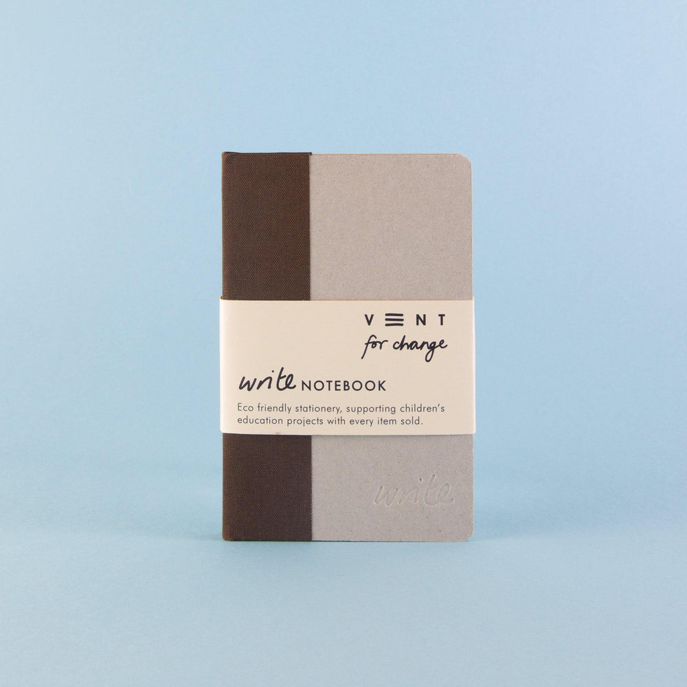 A Brown Sustainable A6 Write Notebook – Dotted Paper with a brown and light gray cover is displayed against a light blue background. It has a beige band with the text "VENT for Change" and "write NOTEBOOK," highlighting its eco-friendly nature and support for children's education projects with each sale.