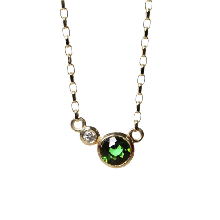 The Madeleine Verdant Embrace 9ct Yellow Gold Necklace features a round green tourmaline and a smaller lab-grown diamond set side by side in gold bezels.