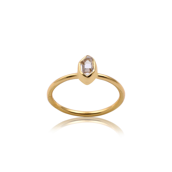 A simple gold vermeil ring featuring a single, irregularly shaped diamond set in a smooth gold band. This piece of handmade jewellery showcases the diamond slightly raised and centrally positioned, with the ring resting on a white background.

Herkimer Quartz Gold Ring by Watermelon tropical.