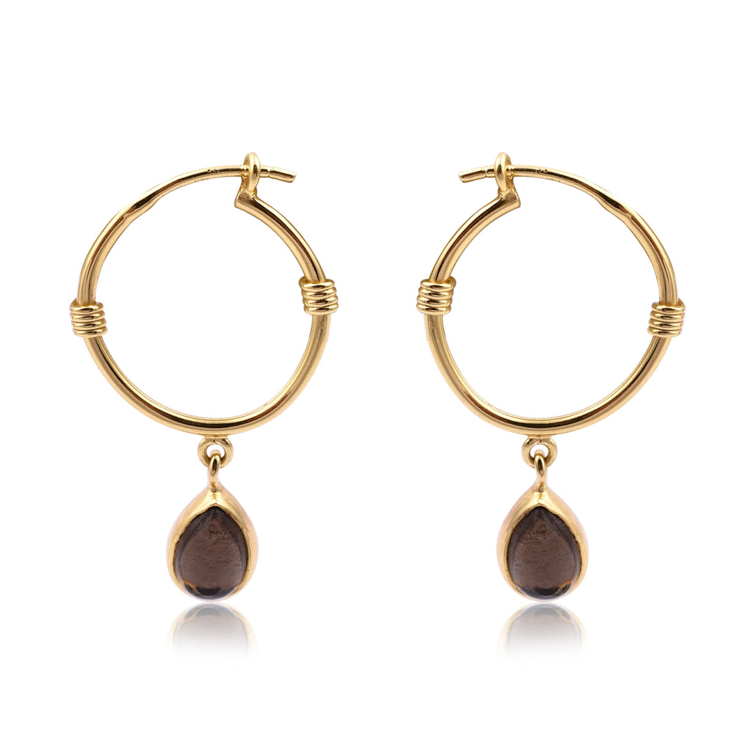 A pair of Watermelon tropical Smoky Gold Dangle Hoops featuring a small gold and brown teardrop-shaped pendant hanging from each hoop. The hoops have a clasp closure and a simple, elegant design with minimal detailing. These handmade jewellery pieces are elevated by the addition of sophisticated teardrop pendants.