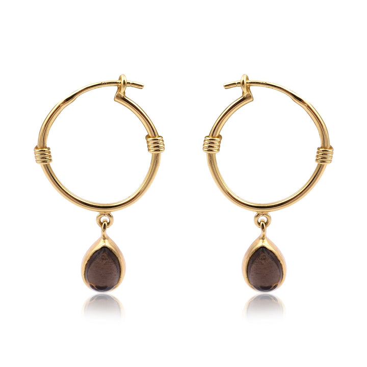 A pair of Watermelon tropical Smoky Gold Dangle Hoops featuring a small gold and brown teardrop-shaped pendant hanging from each hoop. The hoops have a clasp closure and a simple, elegant design with minimal detailing. These handmade jewellery pieces are elevated by the addition of sophisticated teardrop pendants.