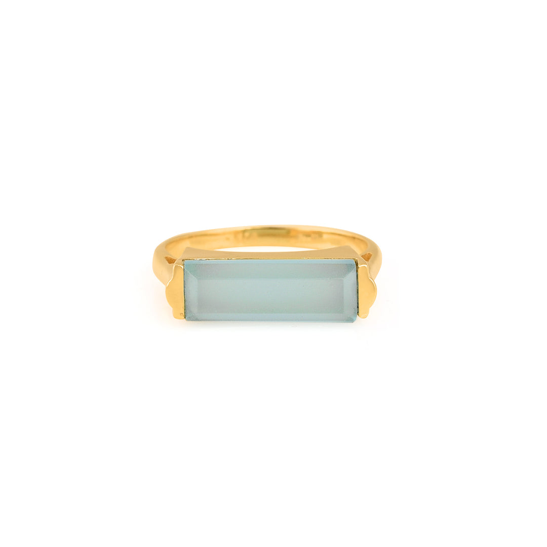 Gold plated ring with long, rectangular pale blue stone.
