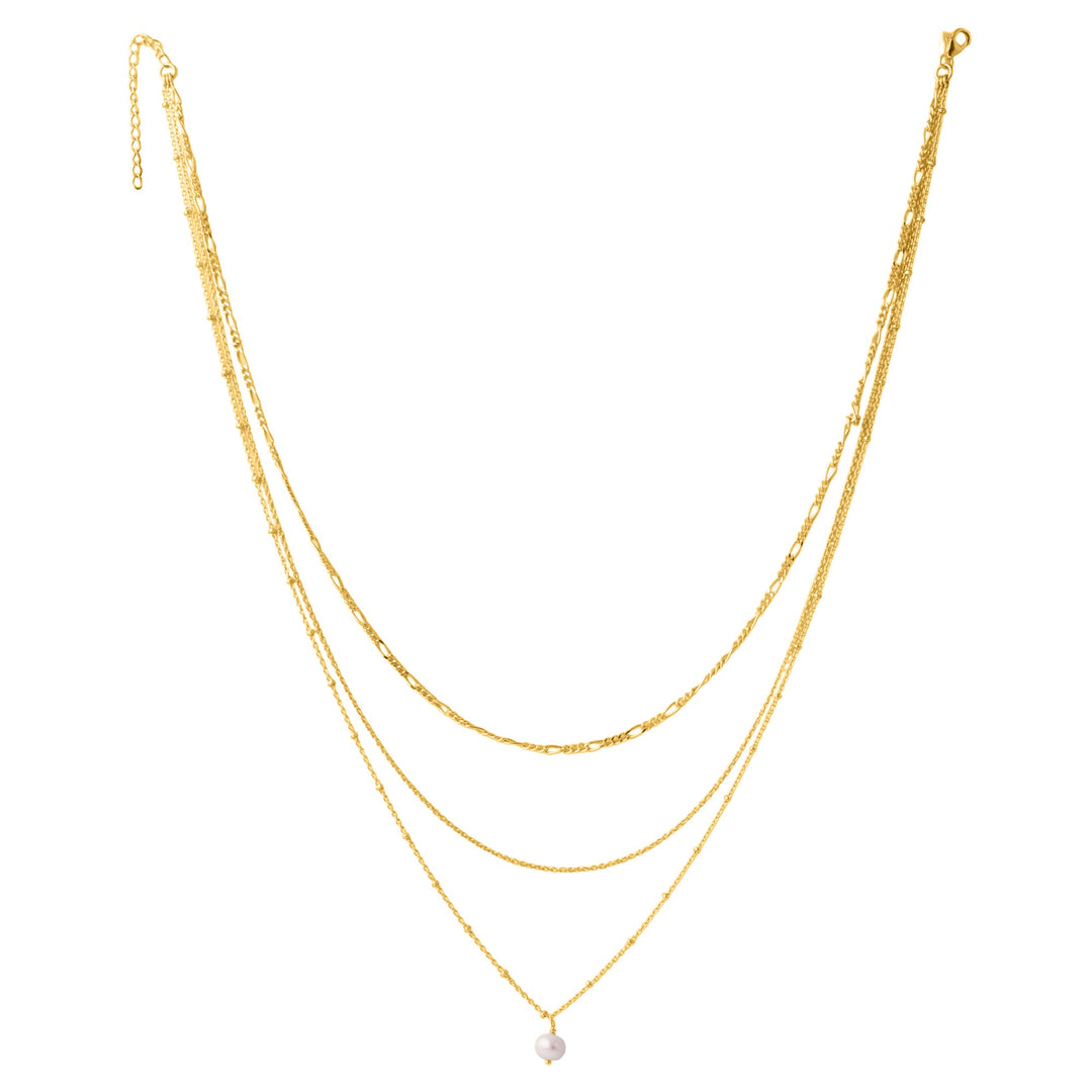 The Carmen necklace from Watermelon Tropical is a stunning gold vermeil layered piece featuring three delicate chains of varying lengths. The shortest chain is unembellished, the middle chain is slightly longer and also plain, and the longest chain showcases a small single pearl pendant, epitomizing the elegance of triple chain necklaces.