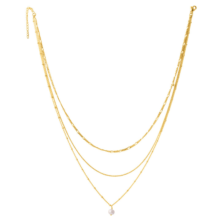 The Carmen necklace from Watermelon Tropical is a stunning gold vermeil layered piece featuring three delicate chains of varying lengths. The shortest chain is unembellished, the middle chain is slightly longer and also plain, and the longest chain showcases a small single pearl pendant, epitomizing the elegance of triple chain necklaces.