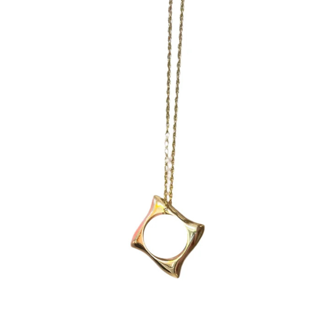 The Waves Necklace Gold by Andrea Mears Jewellery features an 18ct gold plated, abstract open square pendant on a delicate chain—perfect for ocean-inspired jewelry lovers. Shown against a white background.