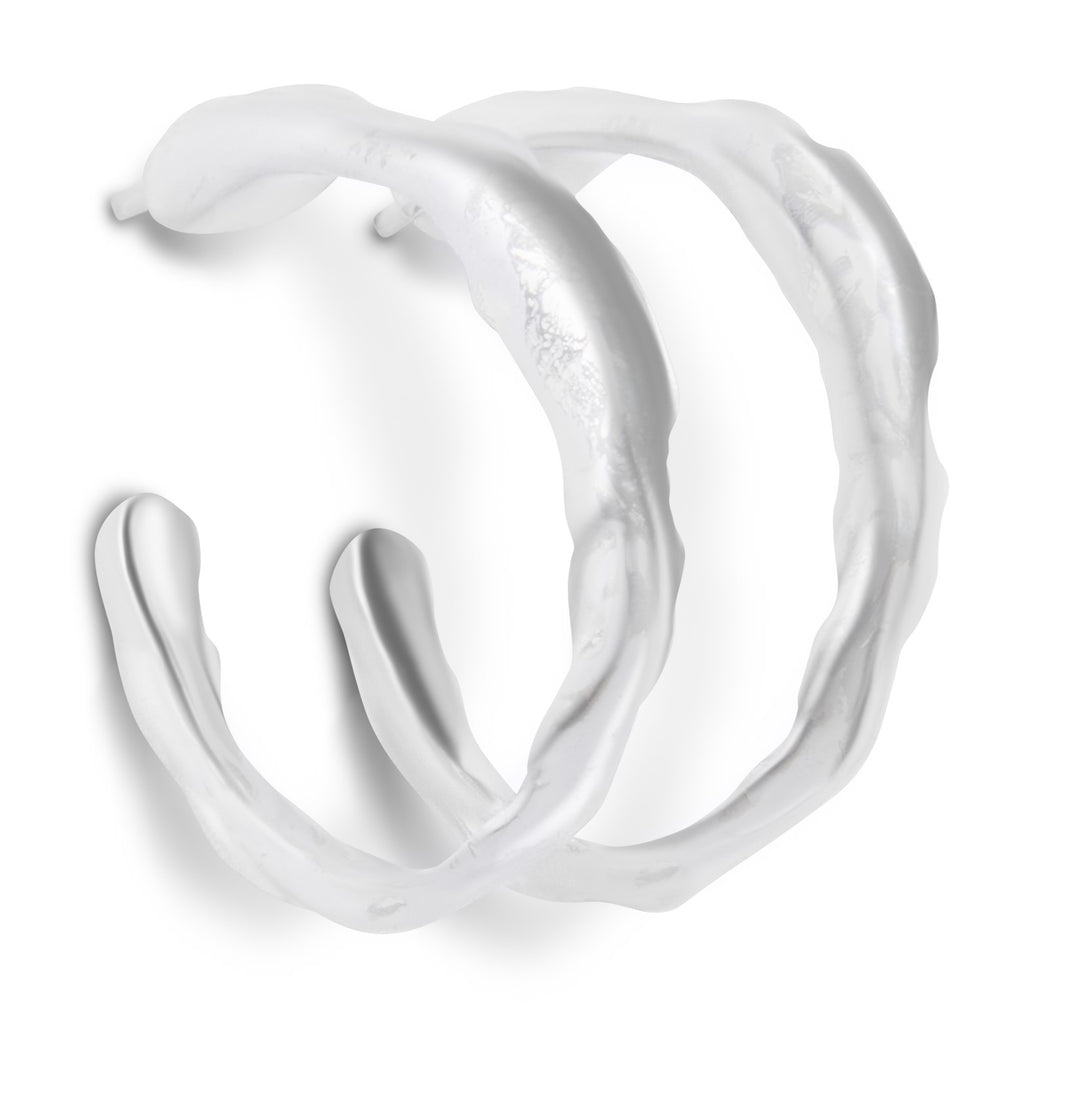 The Waves of The Irish Sea Silver Hoop Earrings by Ava Jane Jewellery are irregularly shaped hoops with a wavy, organic texture, inspired by the Irish Sea and shown on a white background.