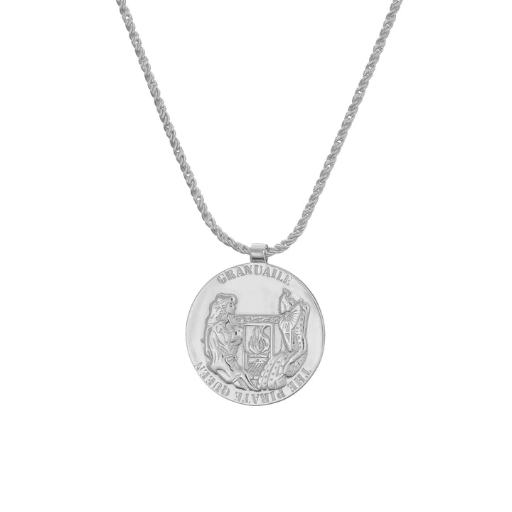 The Grace O'Malley Medallion Small by Jennifer Kinnear is a silver necklace featuring a round pendant with embossed designs of a lion and a unicorn flanking a shield, reminiscent of Queen Elizabeth I medallions. The chain showcases an elegant twisted rope pattern, all set against a plain white background.