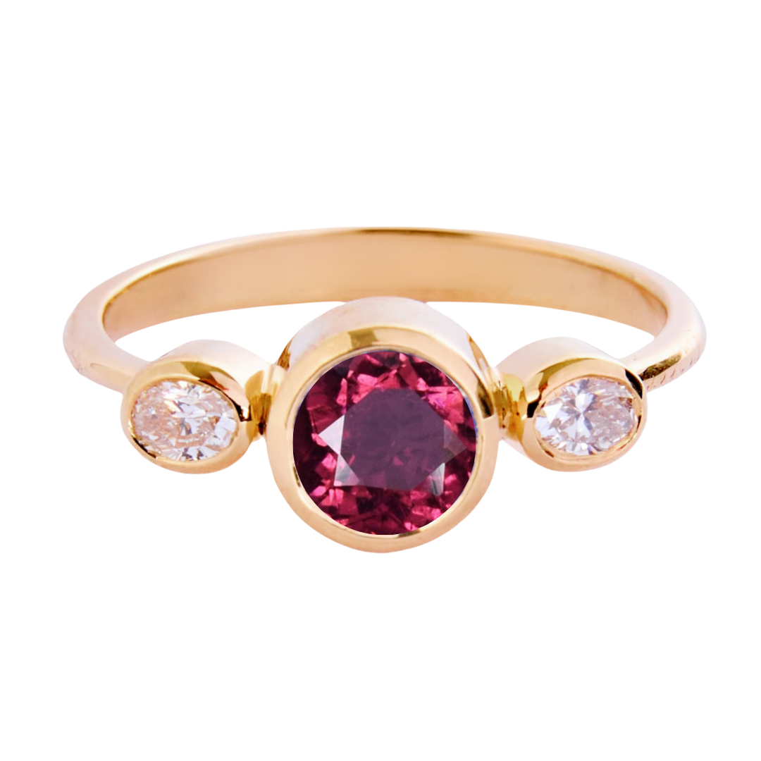 The Celestial Halo 9ct yellow gold ring by Madeleine Fine Jewellery features a vibrant red tourmaline center, accented with natural diamonds for added sparkle.