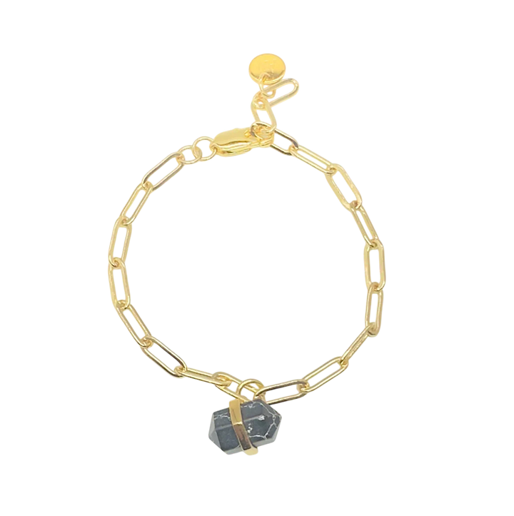 The Aria V Ayin Bracelet features elongated gold chain links and a dark gemstone pendant secured by a gold band, shown on a white background.