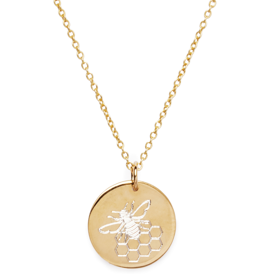 The Symbol Necklace by Personalised Charms features a round gold pendant engraved with a bee and honeycomb, hanging on a delicate chain for a unique, personalized touch.