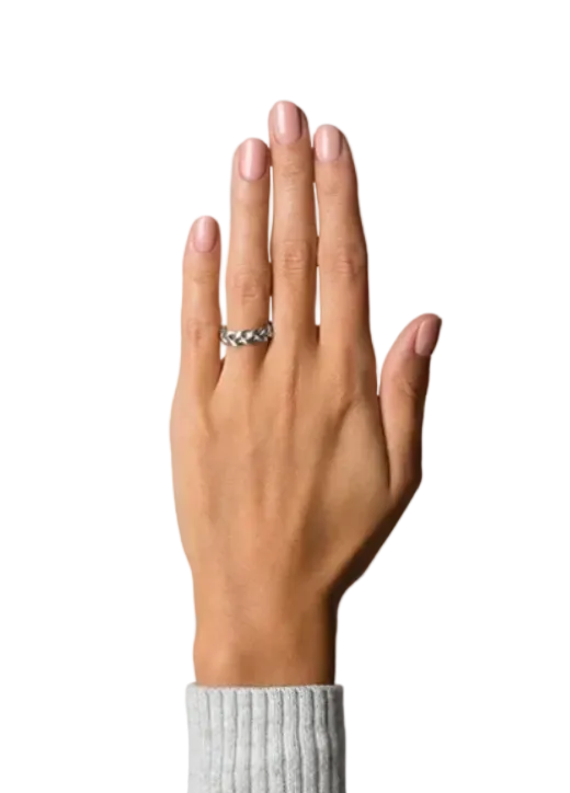 A close-up of a person's hand wearing a silver band ring with a textured, woven-like pattern, set against a solid white background.