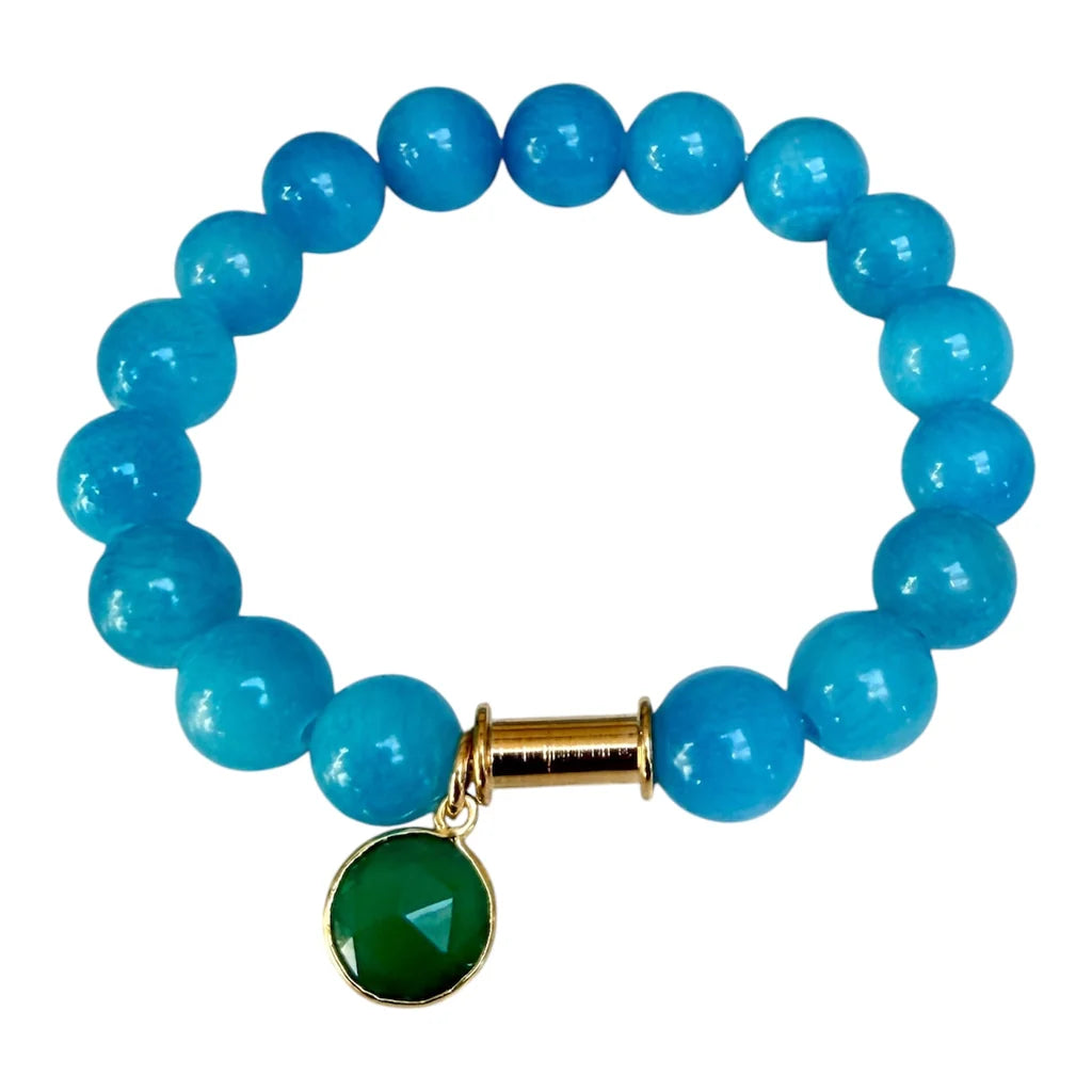 The Aria V Soulstone Blue Chalcedony and Green Onyx Bracelet, handcrafted in Dublin with round blue chalcedony beads and a small gold charm holder adorned with a faceted green onyx pendant, is displayed on a white background.