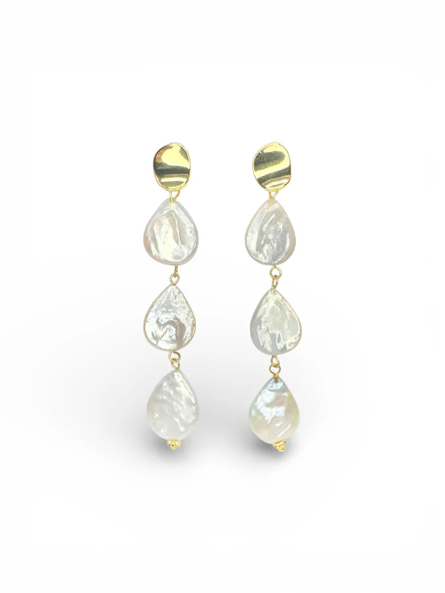 Pair of gold and pearl drop earrings on a white background. Three pearls in the drop.
