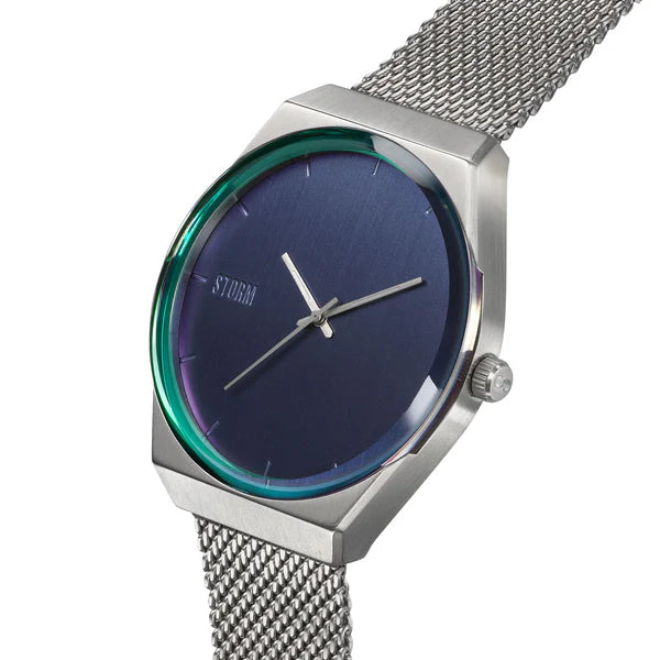 A sleek wristwatch with a silver hexagonal case and a blue dial. The Storm Cirero Blue Watch has silver hour, minute, and second hands, and the brand name "Storm Watches" is inscribed on the dial. Featuring a contemporary design, the band is crafted from sustainable materials in a silver mesh pattern.