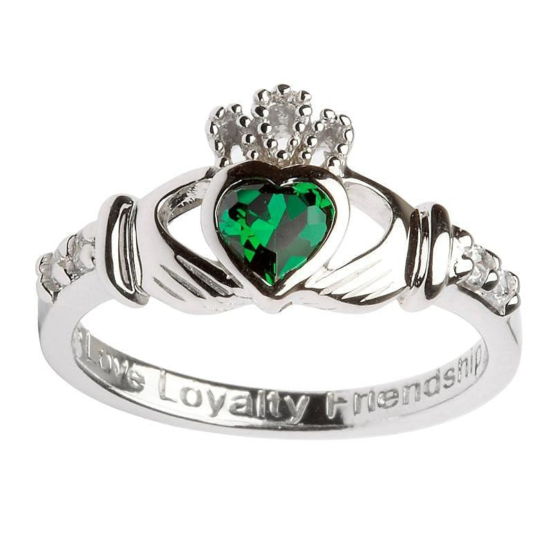 Claddagh ring with green stone as the heart and two clear stones either side of the hands. The words love, loyalty and friendship are engraved on the band. 