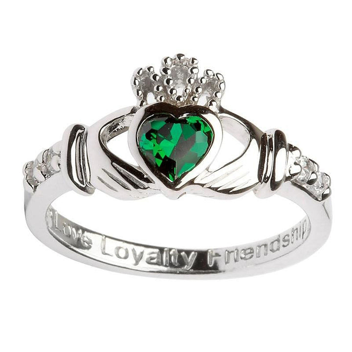 Claddagh ring with green stone as the heart and two clear stones either side of the hands. The words love, loyalty and friendship are engraved on the band. 