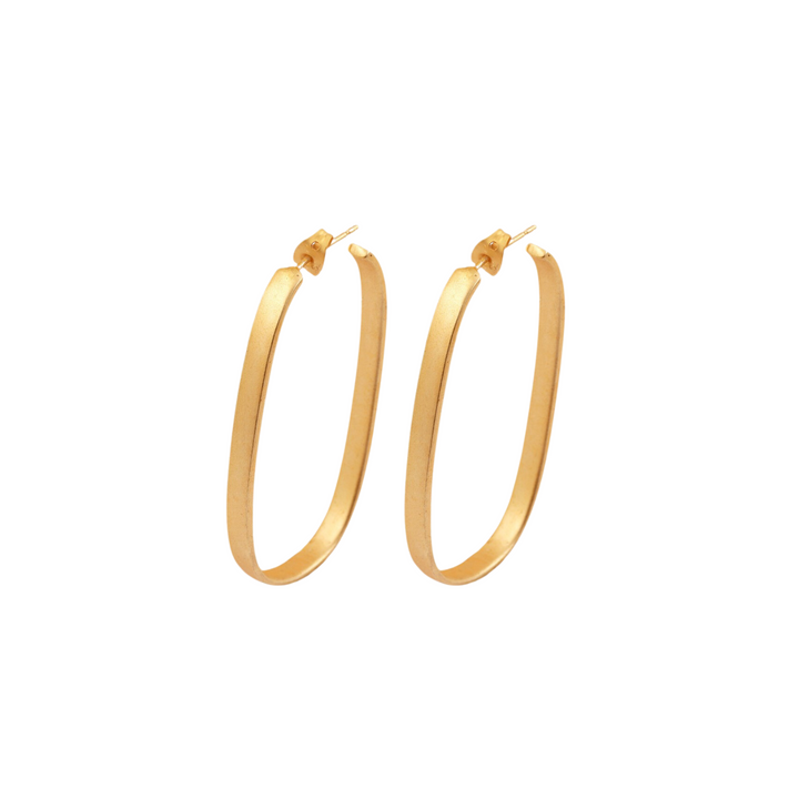 A pair of Clara Gold Drop Hoops from Watermelon Tropical with a thin, smooth design are shown against a white background. The clasps are visible at the top, indicating they are designed for pierced ears. The earrings have a simple yet elegant appearance, reminiscent of long drop styles despite being gold hoops.