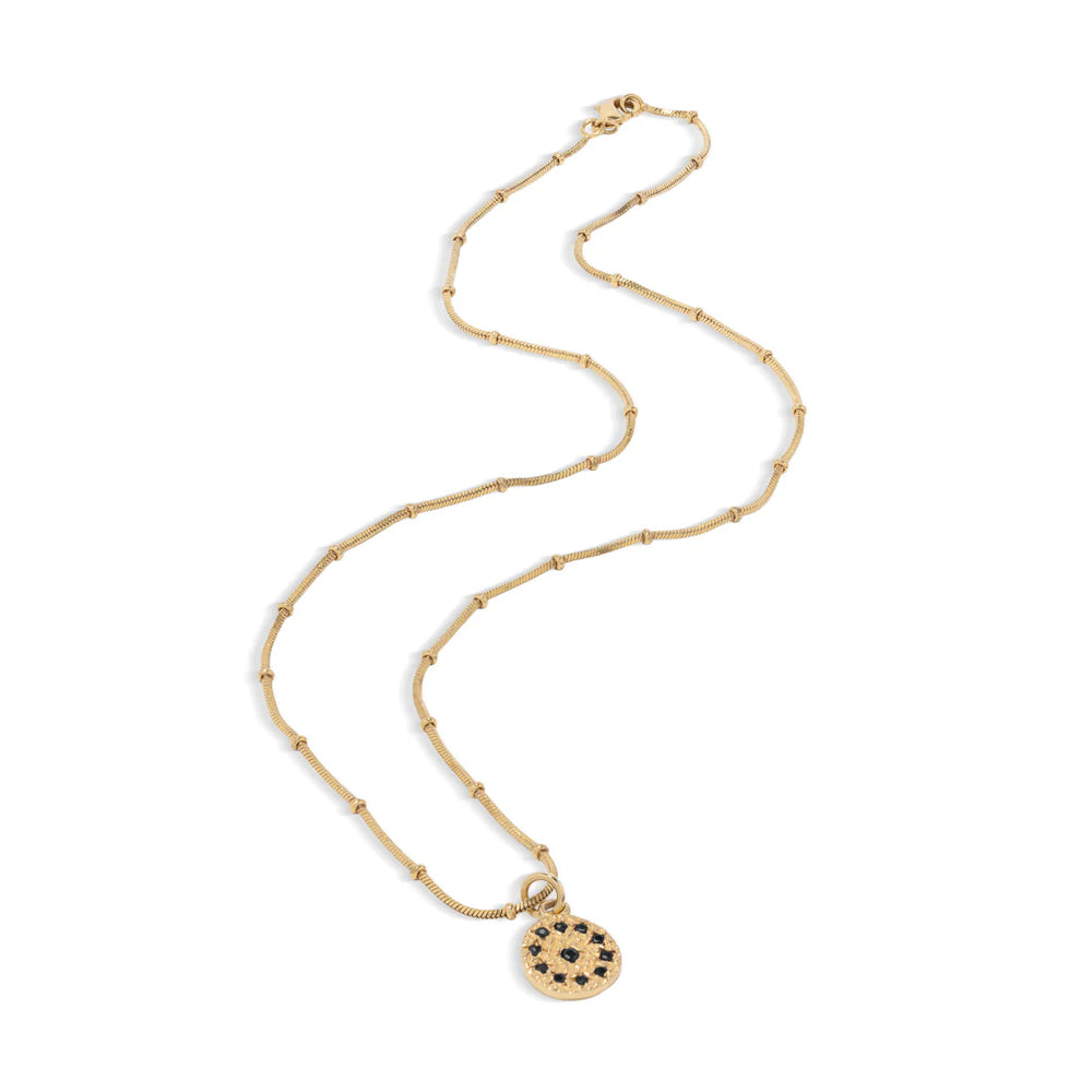 Gold necklace with a round pendant on a white background.