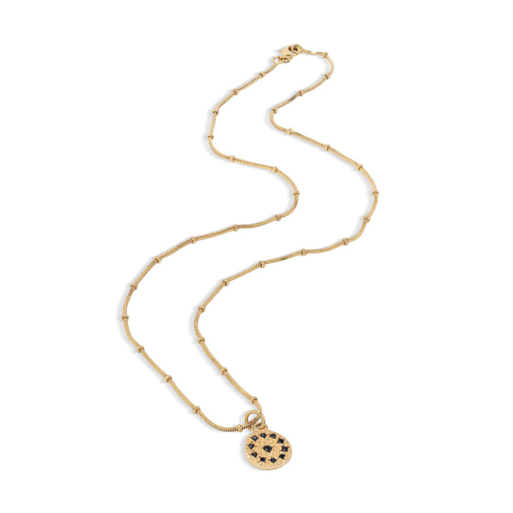 Gold necklace with a round pendant on a white background.
