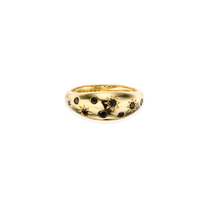 Gold ring with multiple black gemstones on a white background