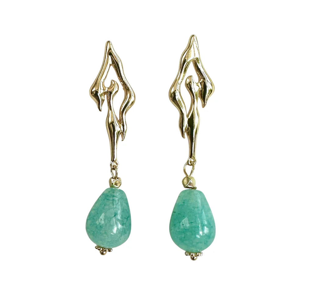 Aria V’s Crystal Earrings feature gold-plated teardrop designs with abstract flame-shaped tops and bold sky blue amazonite gemstone pendants, showcased against a white background.