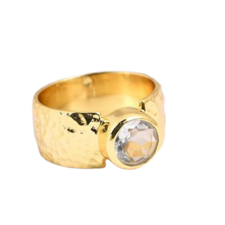 A thick hammered gold band ring featuring a large, round, clear Cubic Zirconia gemstone in a raised setting on the front. The wide band boasts a rich texture with its hammered finish. The **Watermelon Tropical Cubic Zirconia Band Ring** elevates any outfit with its stunning design and luxurious feel.