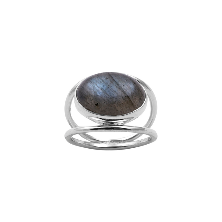 A Double Silver Band Labradorite Ring featuring a large, round labradorite stone set in the center. Handcrafted by Watermelon tropical from sterling silver, the ring has a modern design with two parallel bands that merge at the back, creating an open, airy look around the gemstone. The labradorite displays a play of blue and gray colors.