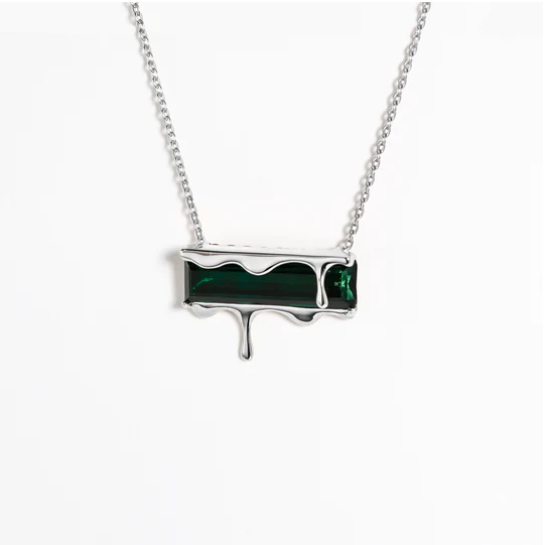 Marie June Jewellery presents the Dripping Gemstone Pendant Necklace Silver, showcasing a rectangular green gemstone elegantly draped with sterling silver to create a striking melting effect. The exquisite pendant is suspended from a delicate silver chain, set against a pristine white background.