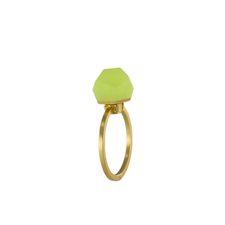 A Fruit Bijoux Fruit Bijoux Ring Top VU Crystals Neon Yellow with a geometric design featuring a matte, hexagonal green gemstone on top. The 24ct gold-plated band has a sleek, simple style that highlights the bold, modern stone.