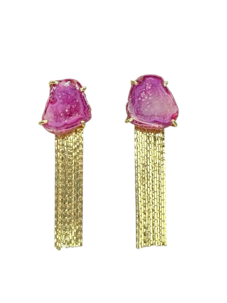 The Aria V Fuschia Geode Tassel Earrings feature rough pink natural stone studs and multiple gold chains elegantly cascading from each for a chic look.