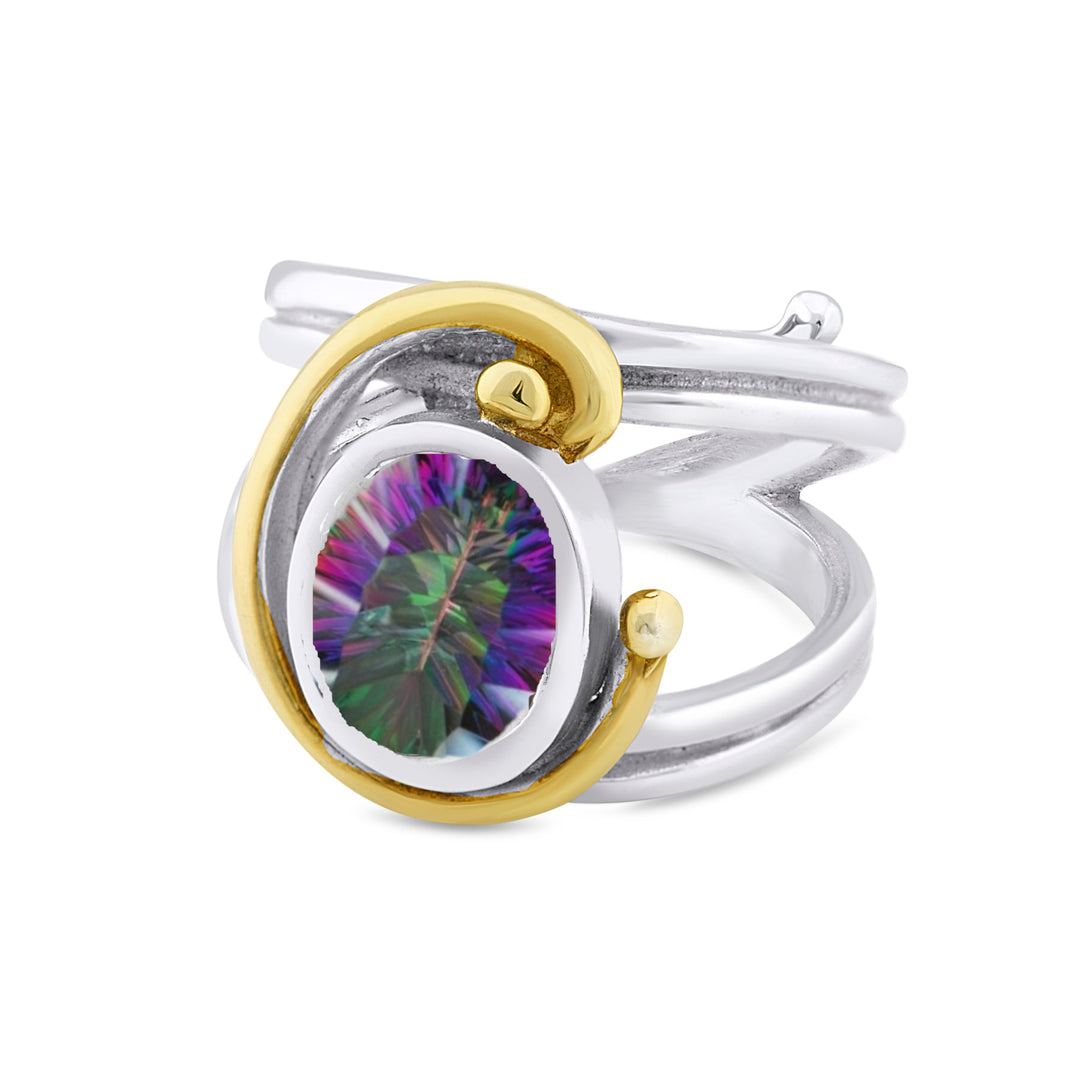 A silver Jasmine Ring in various gemstones with a unique two-band, adjustable design by Gallardo & Blaine Designs features a central round stone that exhibits iridescent colors. The gemstone is accented with gold swirls that wrap around it artistically.
