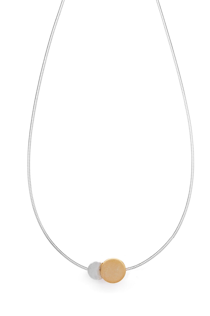 The Gallardo & Blaine Designs Archeol Necklace in Sterling Silver & Gold Vermeil features a minimalist design with a slim chain crafted from sterling silver, adorned with two spherical pendants. One pendant is silver-toned, while the other boasts a contrasting gold vermeil finish, making the piece both elegant and simple.